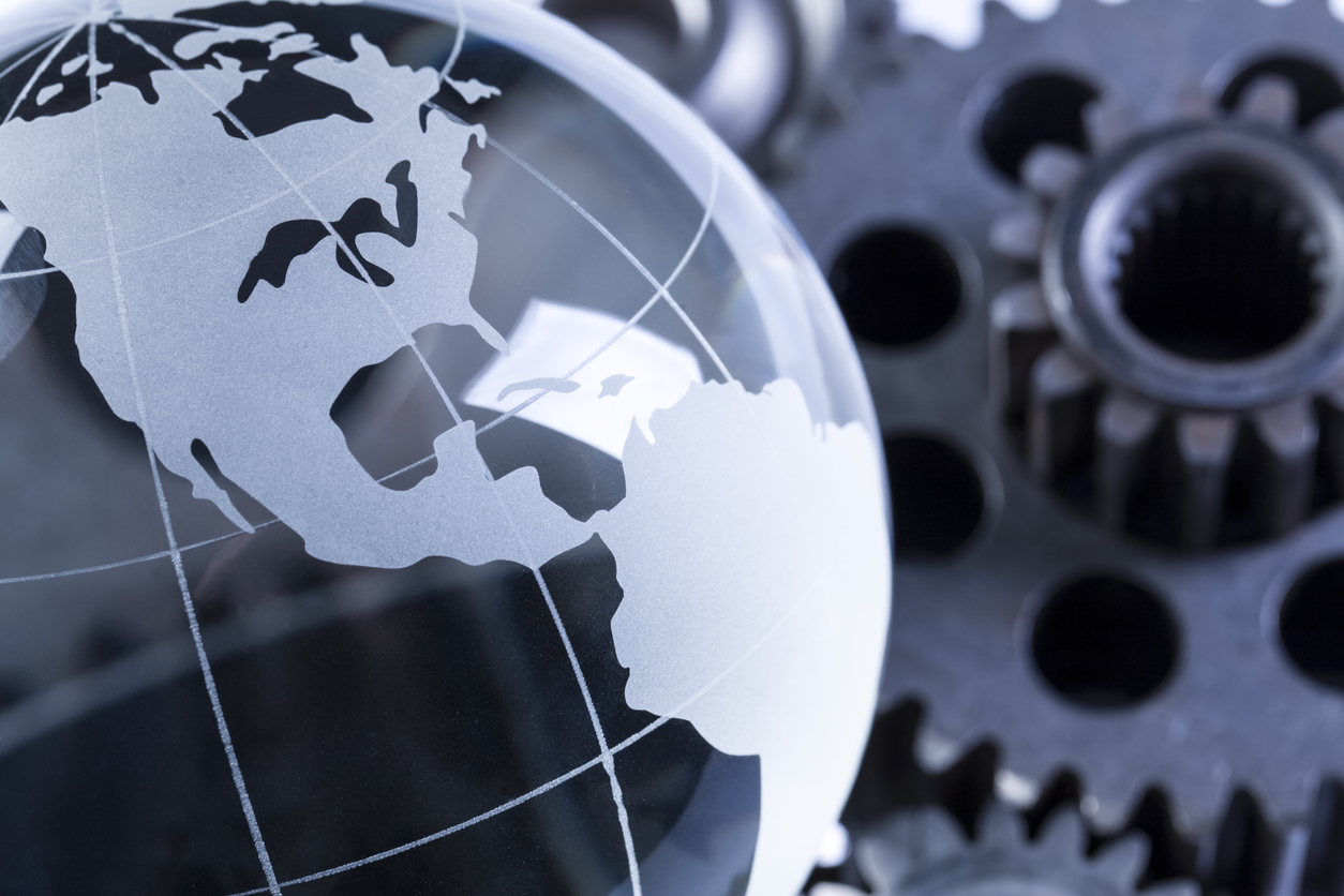 Glass globe on metal gears tinted gold.